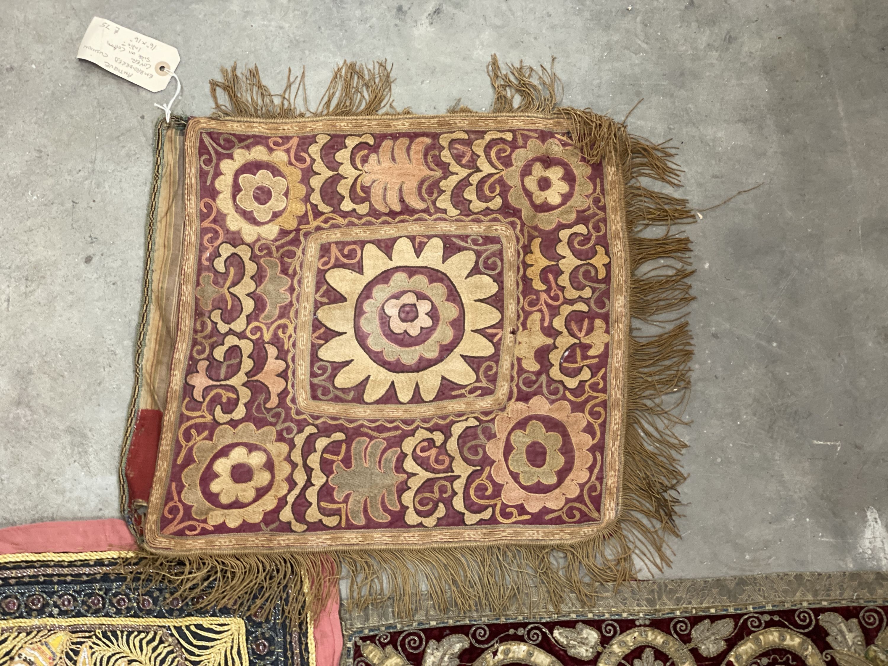 An Indian appliqué panel, two Indian appliqué covers and one other.